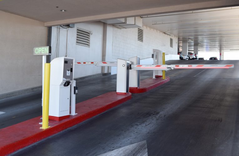 Parking garage pay station with barrier arm.