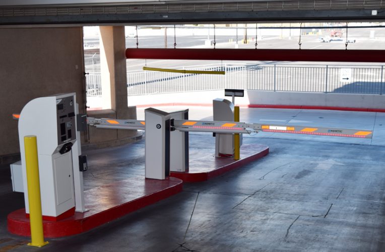 Parking garage pay station with barrier arm.