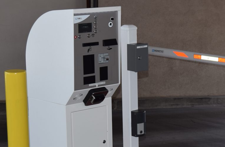 Parking garage pay station with barrier arm.