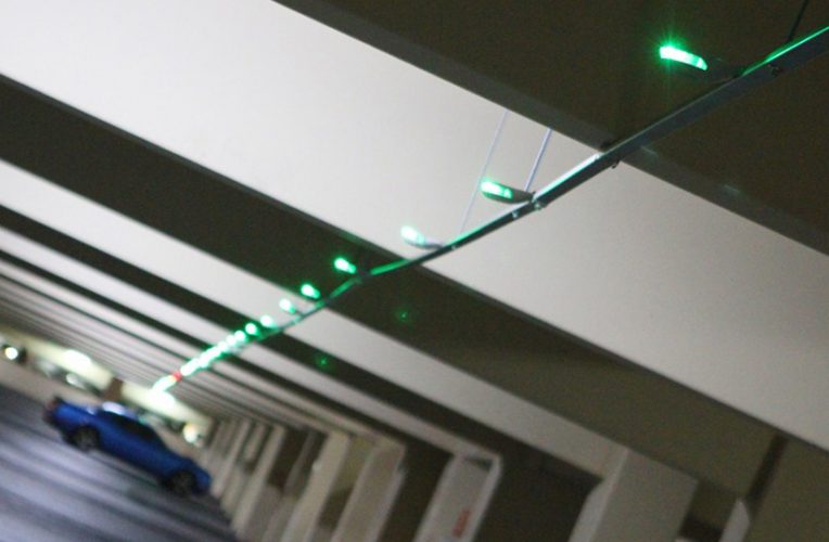 Green parking lights in a garage.