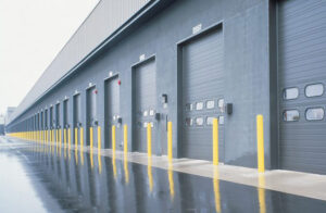 Row of overhead doors on building exterior.